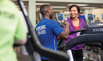 woman on treadmill with personal trainer