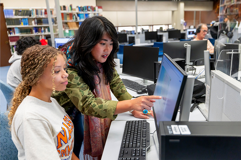 Teacher Helping a student on the computer