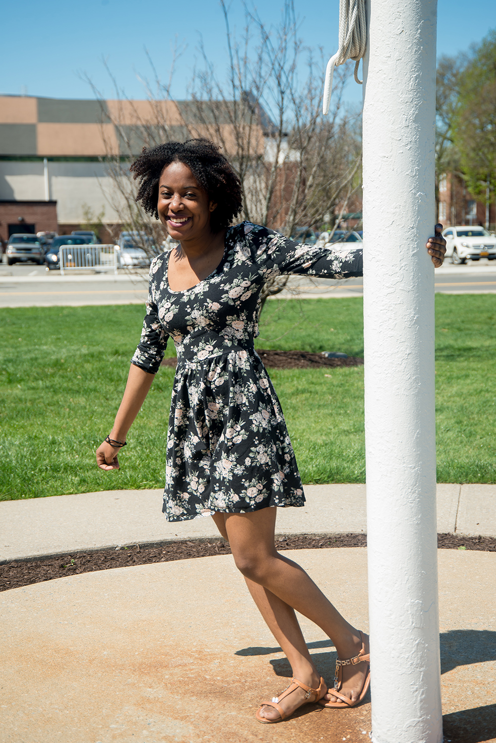 Student standing on campus smiling